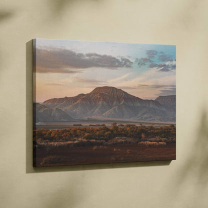 Canvas wall art featuring a majestic mountain and desert landscape at sunset with soft clouds.