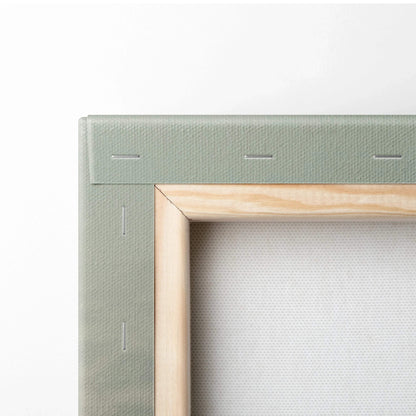 Close-up of wooden frame and stretched canvas corner for wall art display.