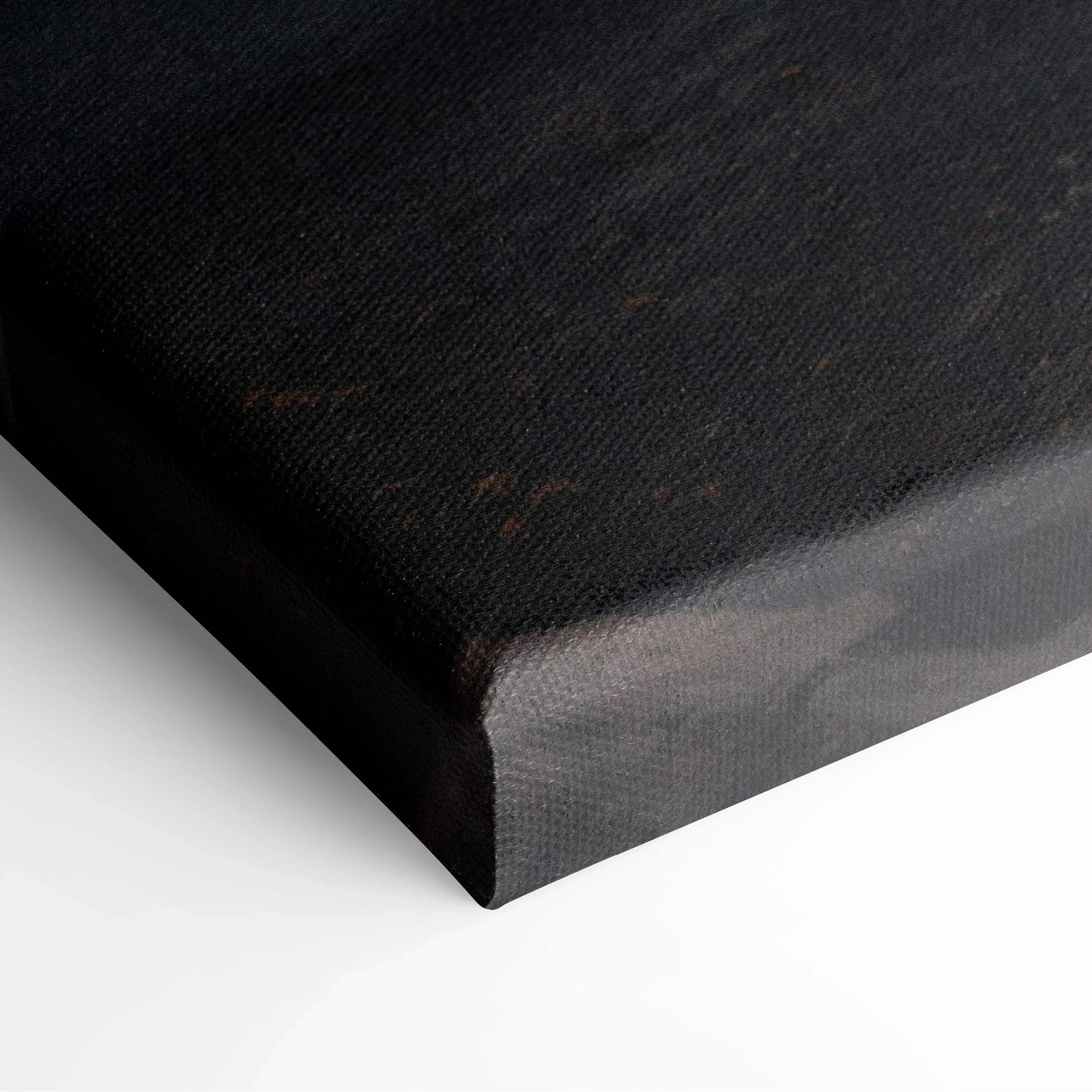 Close-up of black textured canvas corner with subtle brown and gray tones in wall art.