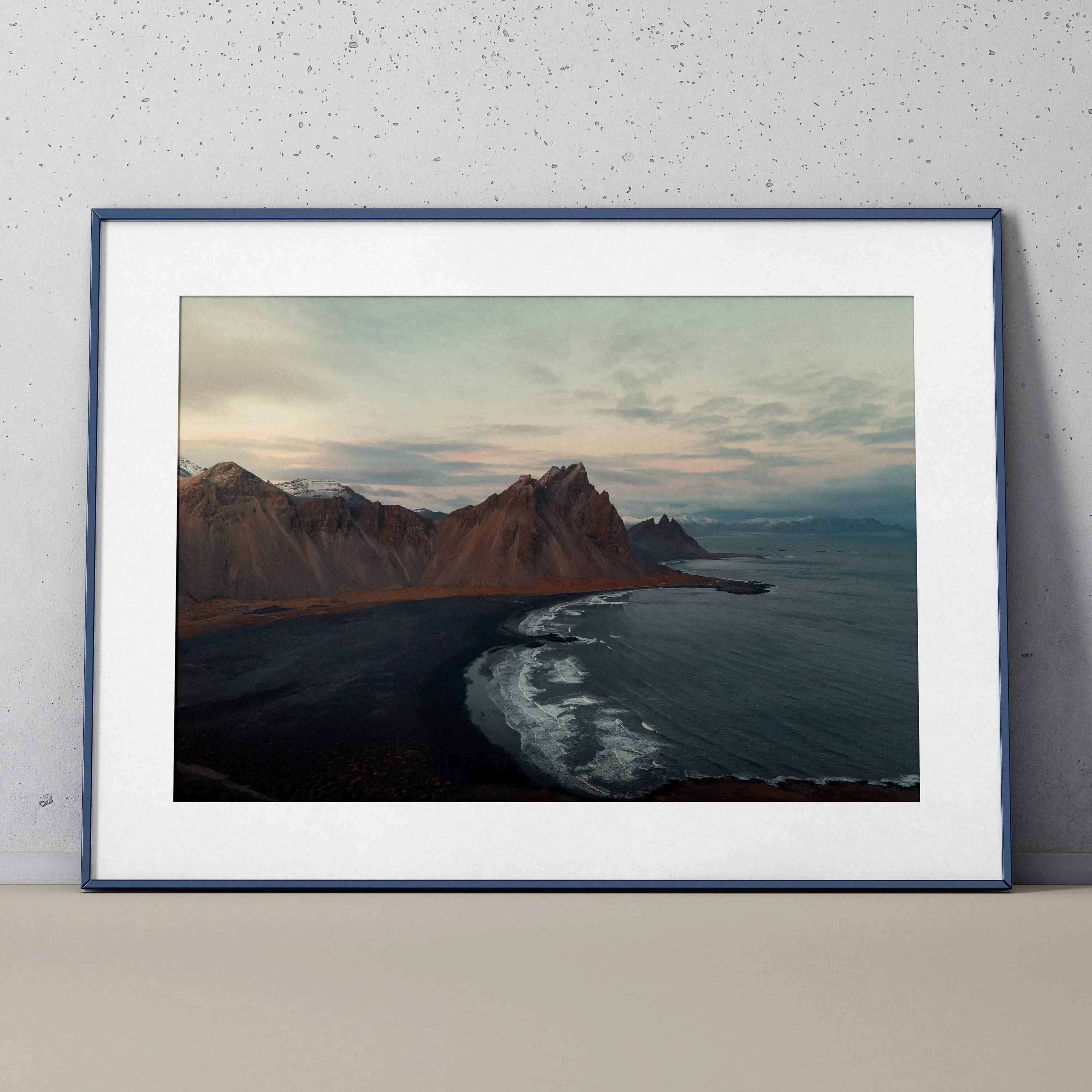 Majestic mountain landscape poster with dark shoreline and ocean waves, nature wall art print.