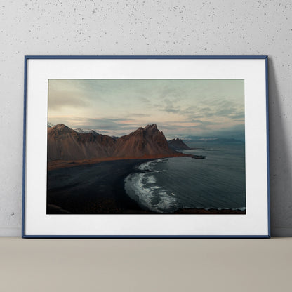 Majestic mountain landscape poster with dark shoreline and ocean waves, nature wall art print.