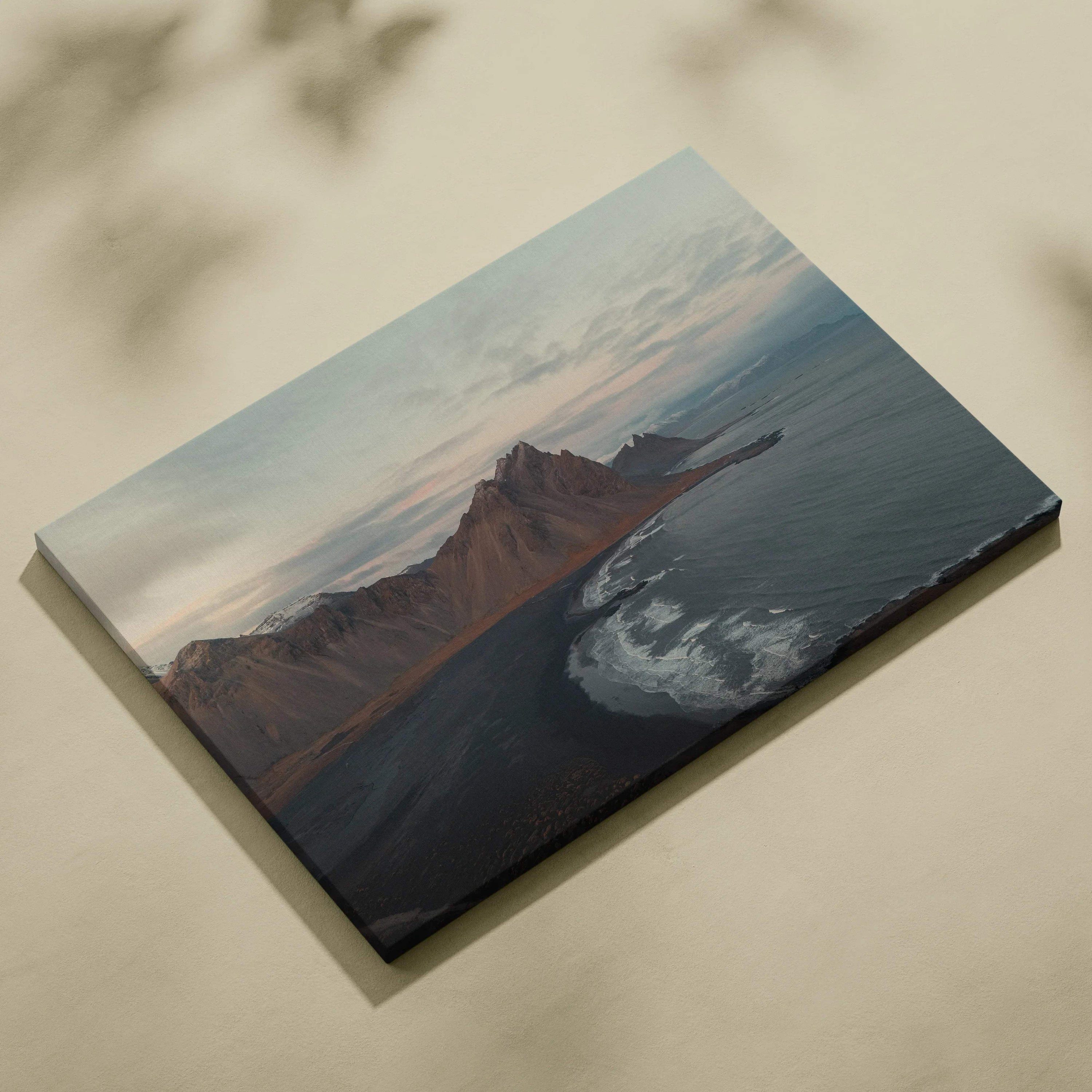 Canvas wall art featuring majestic mountains overlooking a serene beach at sunset with soft pastel skies.