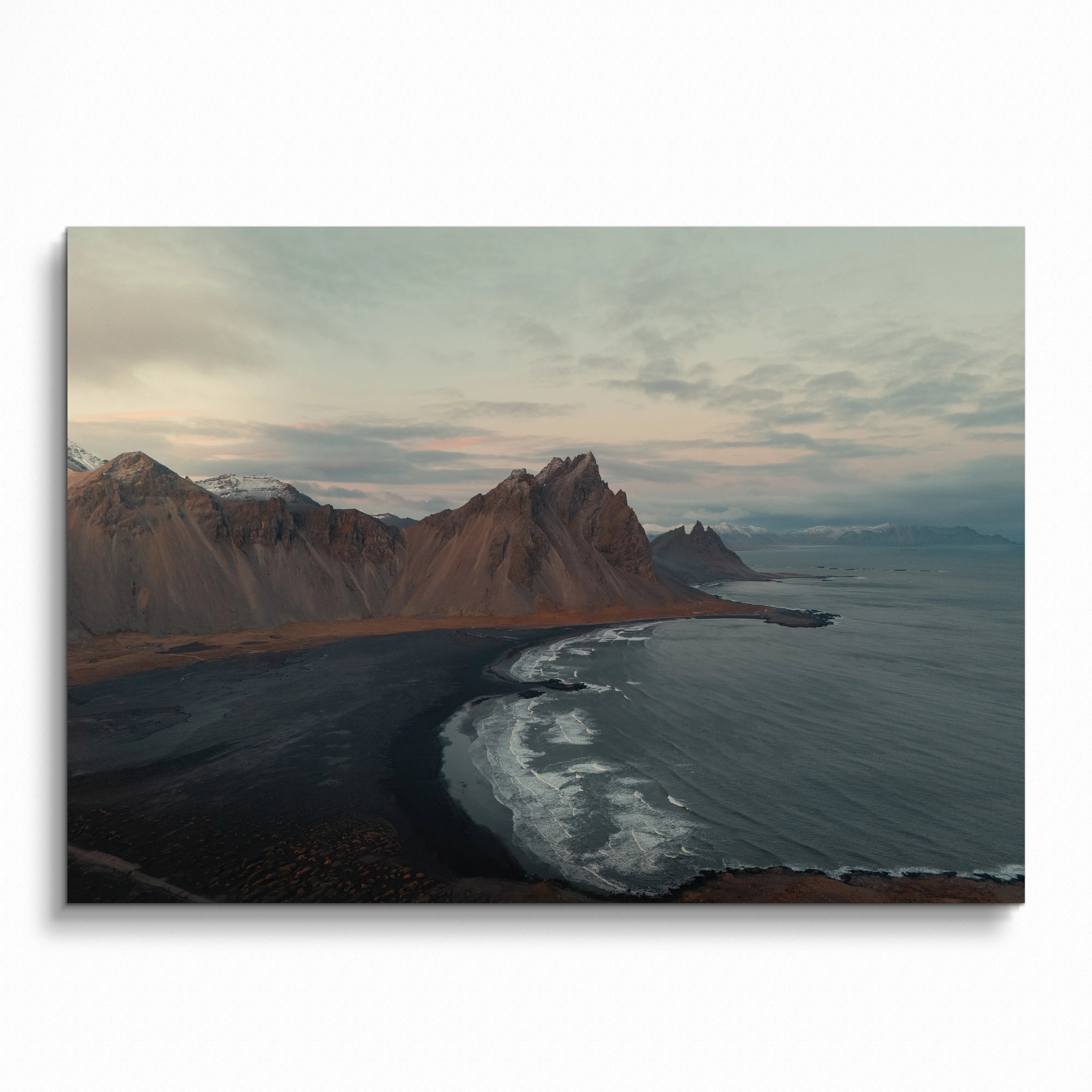 Majestic mountain coastline with waves crashing on black sand beach poster wall art.