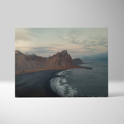 Canvas wall art featuring dramatic mountains and serene beach under a cloudy sky.
