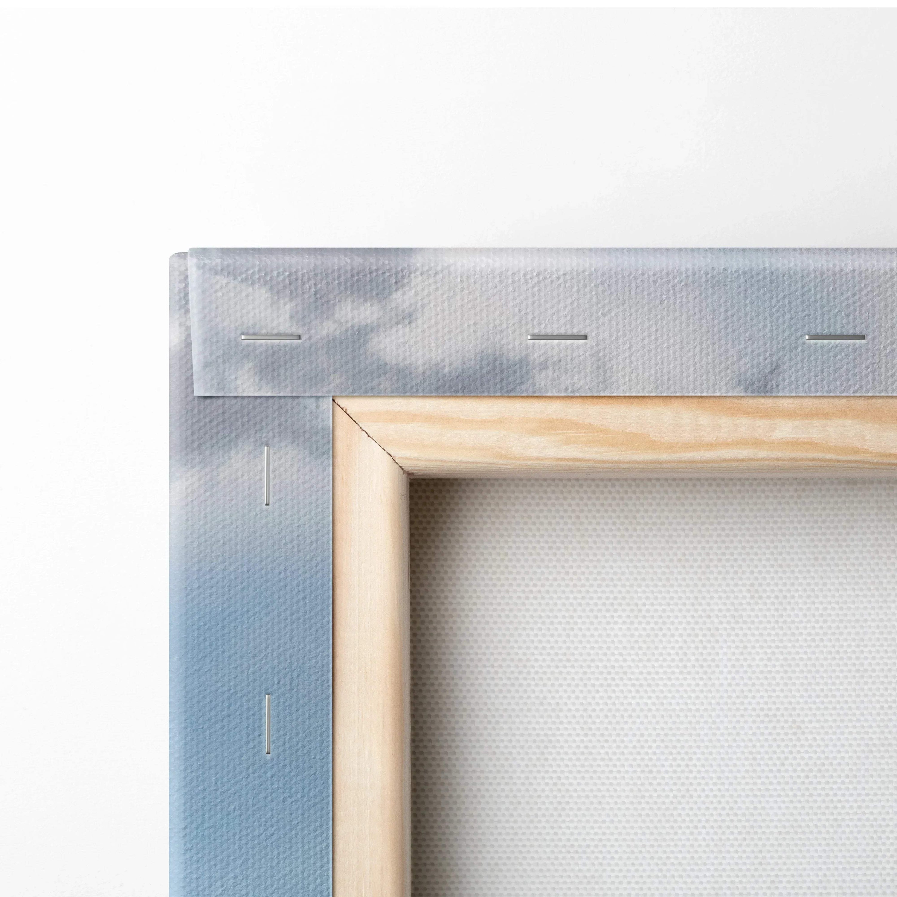 Close-up of wooden frame and stapled edge on canvas wall art print.