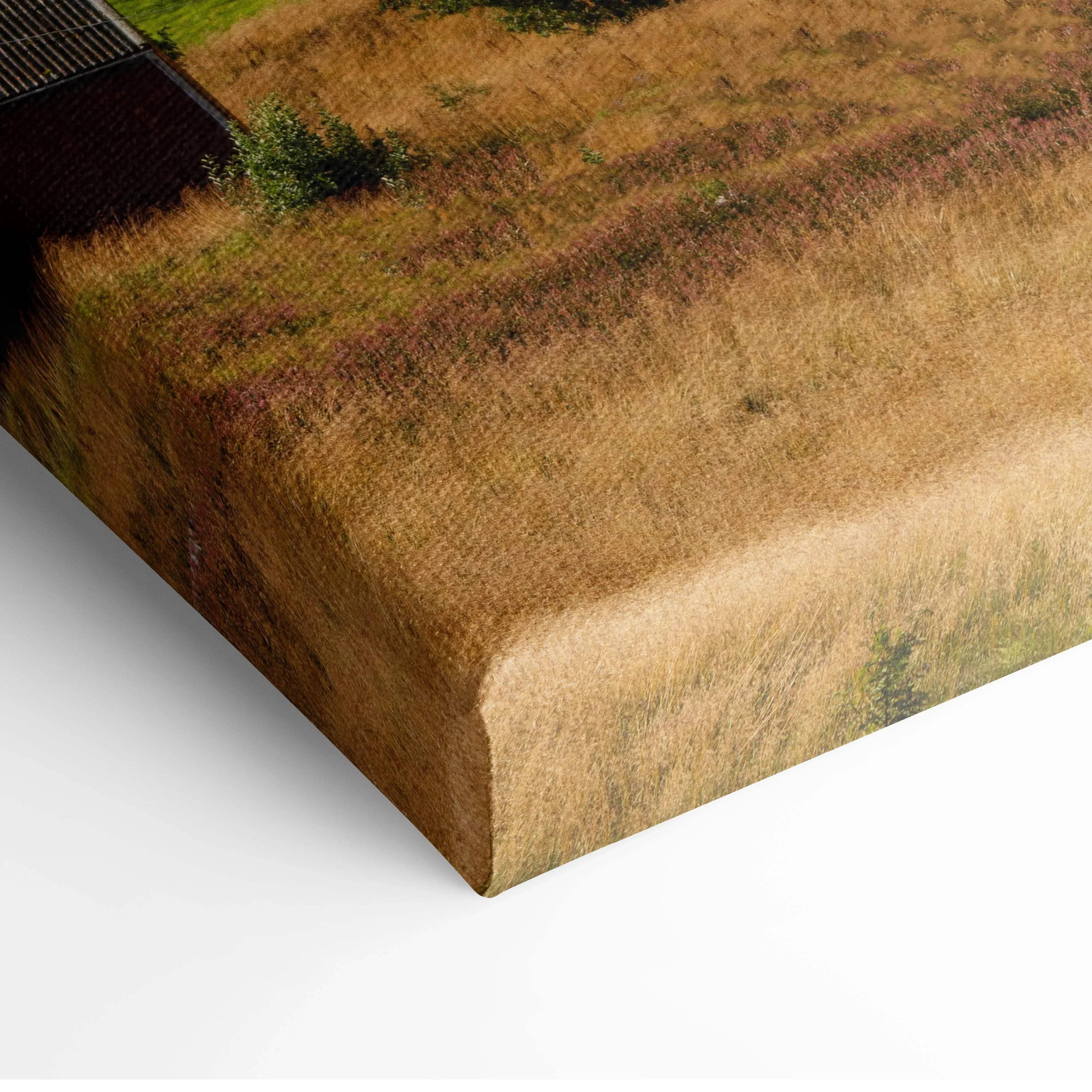 Close-up of canvas wall art corner with textured brushstrokes in warm earthy tones.