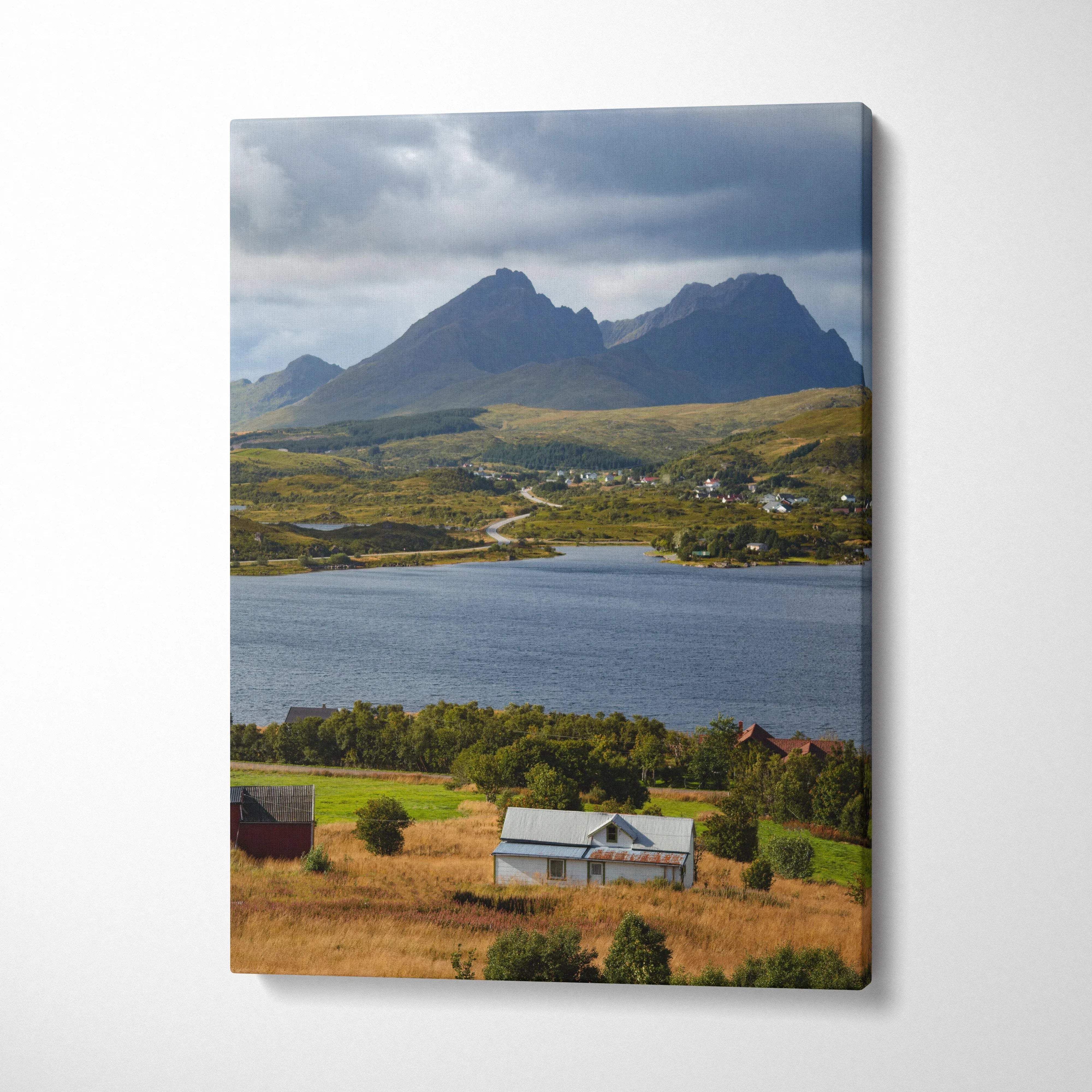 Vertical canvas wall art featuring majestic mountains and a serene lake under a cloudy sky.