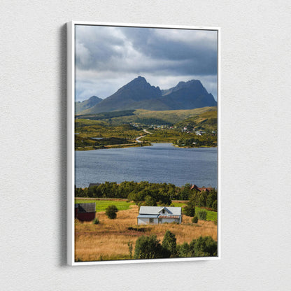 Vertical canvas wall art featuring majestic mountains over a lake with a rural farmhouse foreground.