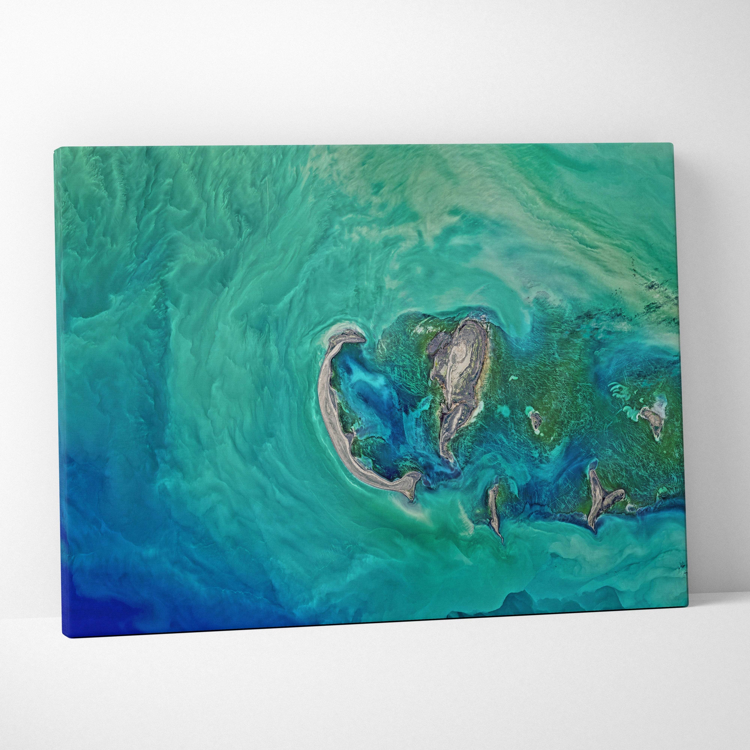Aerial turquoise ocean canvas wall art print featuring a vibrant teal and green abstract swirling oceanic landscape
