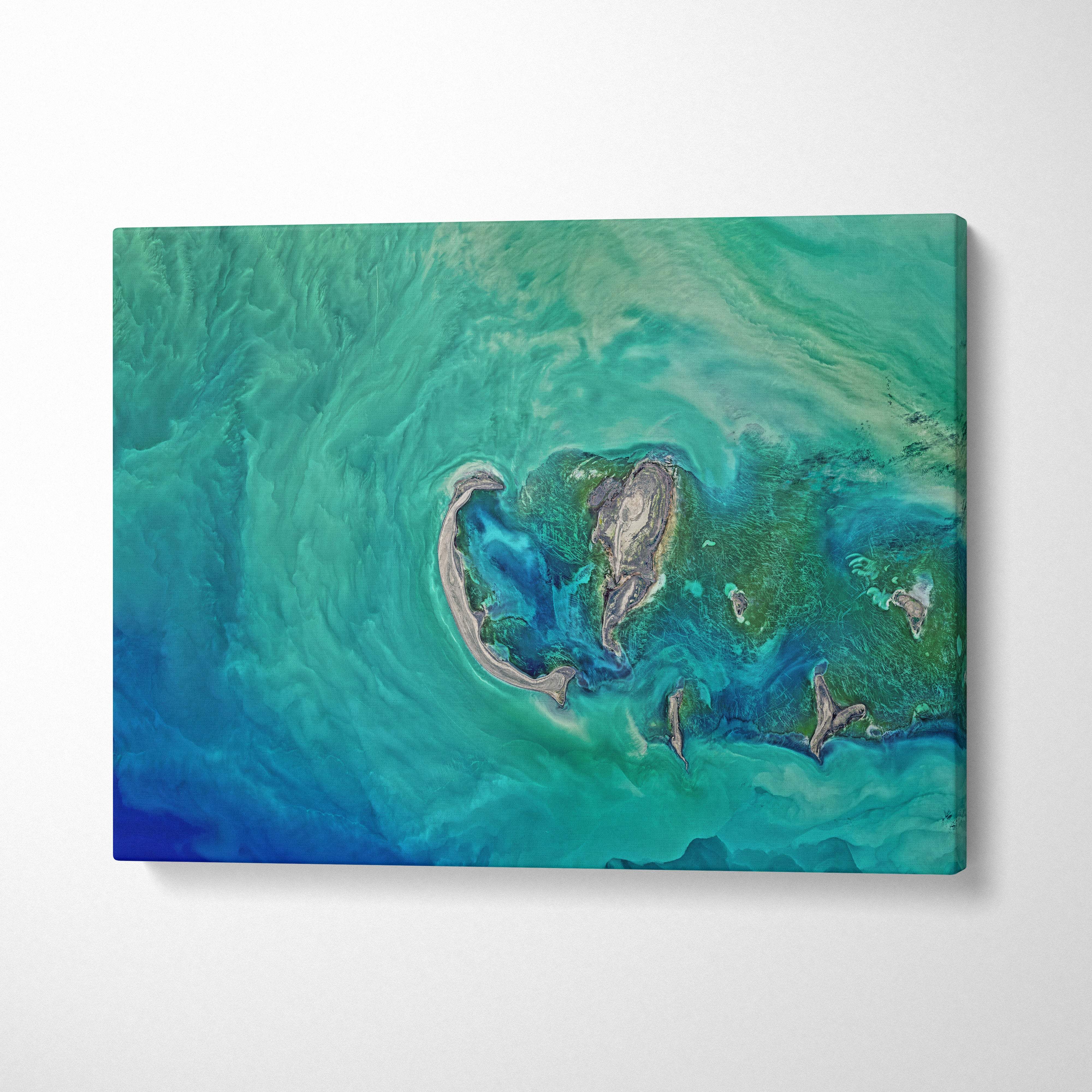 Aerial turquoise ocean canvas wall art print with abstract swirling ocean scene in vibrant blue green tones for coastal decor