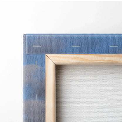 Close-up of framed canvas wall art with a wooden stretcher bar and blue mountain landscape print wrap.