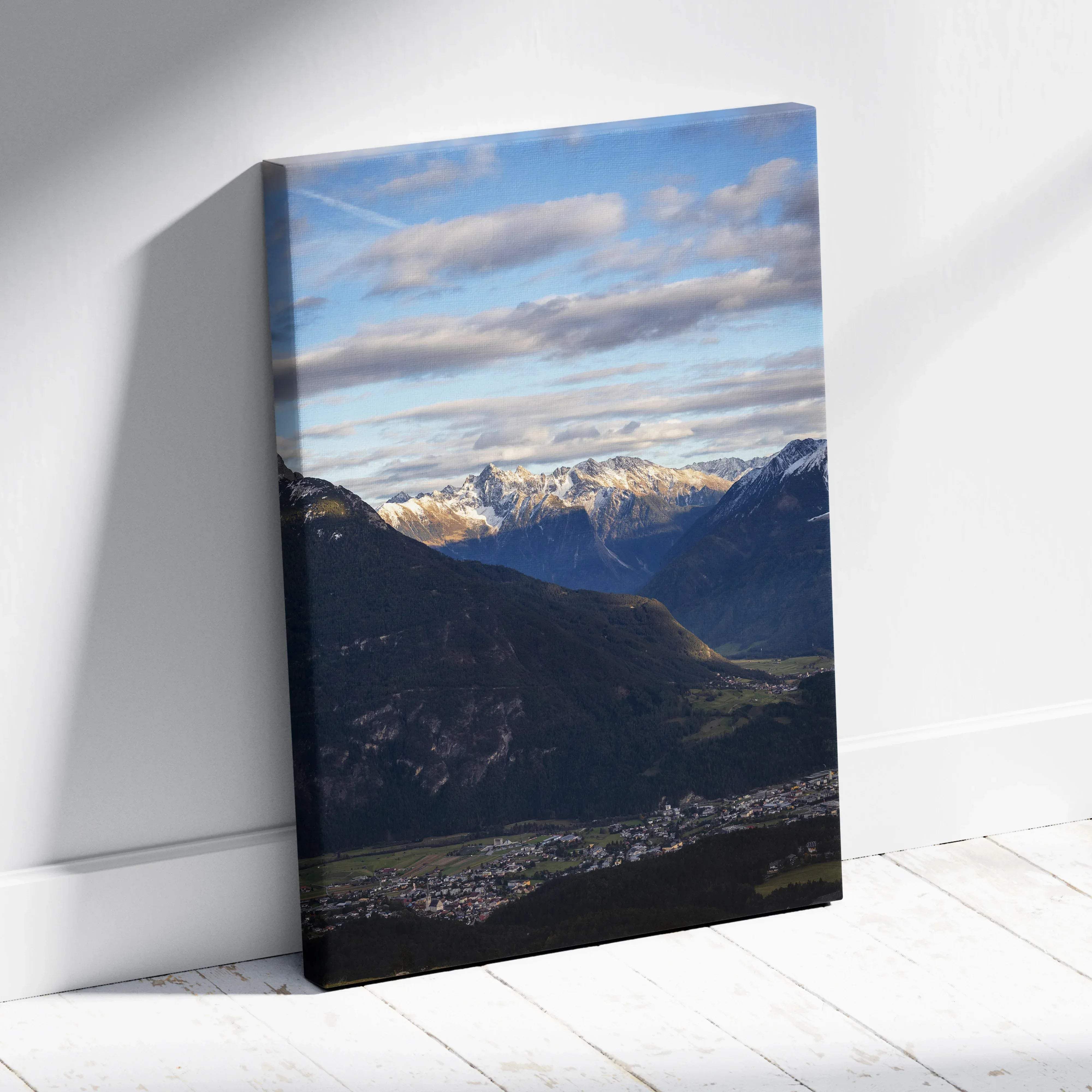 Rectangular canvas print of a scenic mountain landscape with snow-capped peaks and a village under blue skies