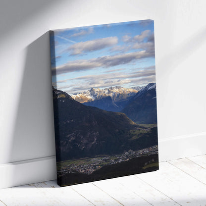 Vertical canvas wall art featuring a majestic mountain landscape with blue sky and clouds.
