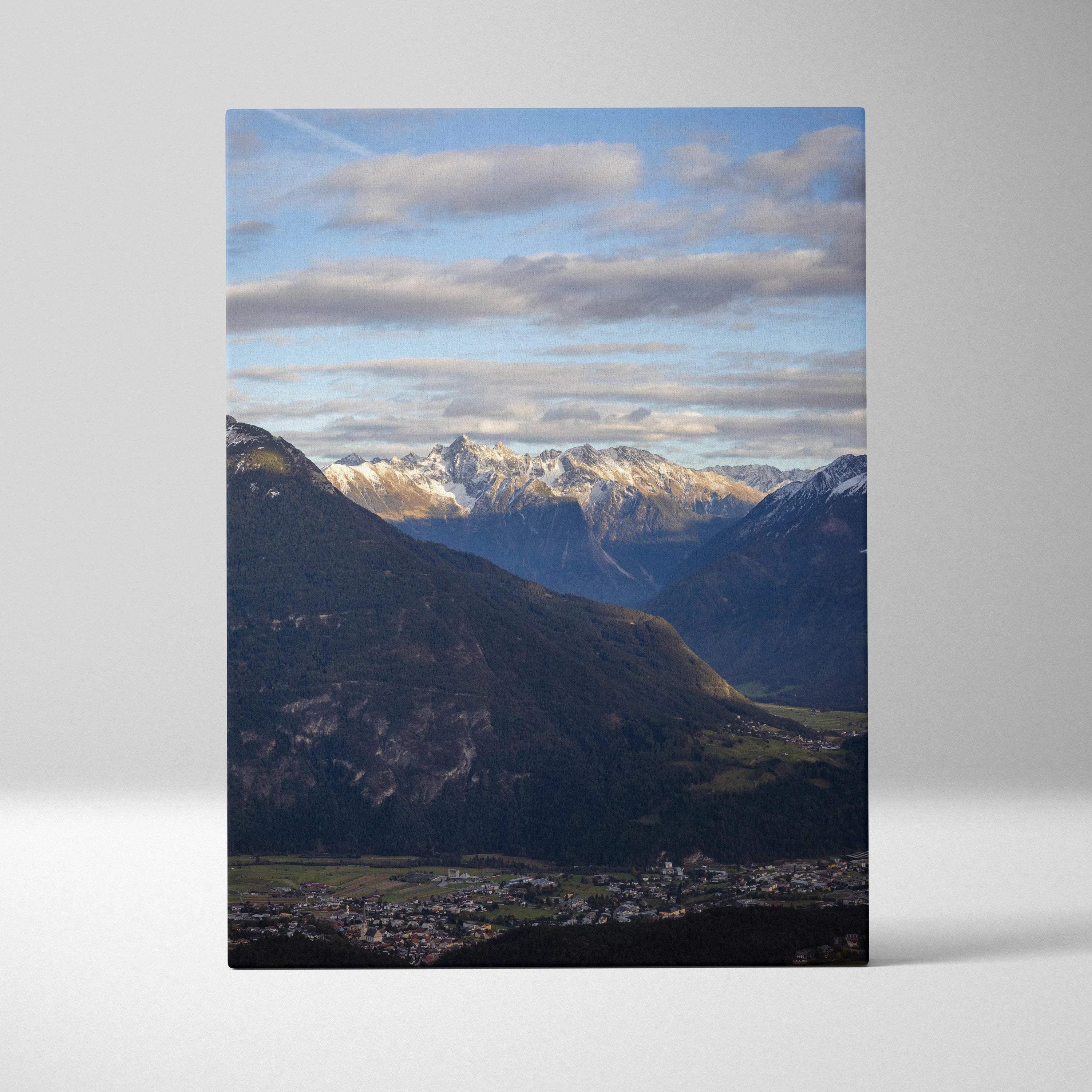 Vertical canvas wall art featuring a majestic snow-capped mountain range under a blue sky with clouds.