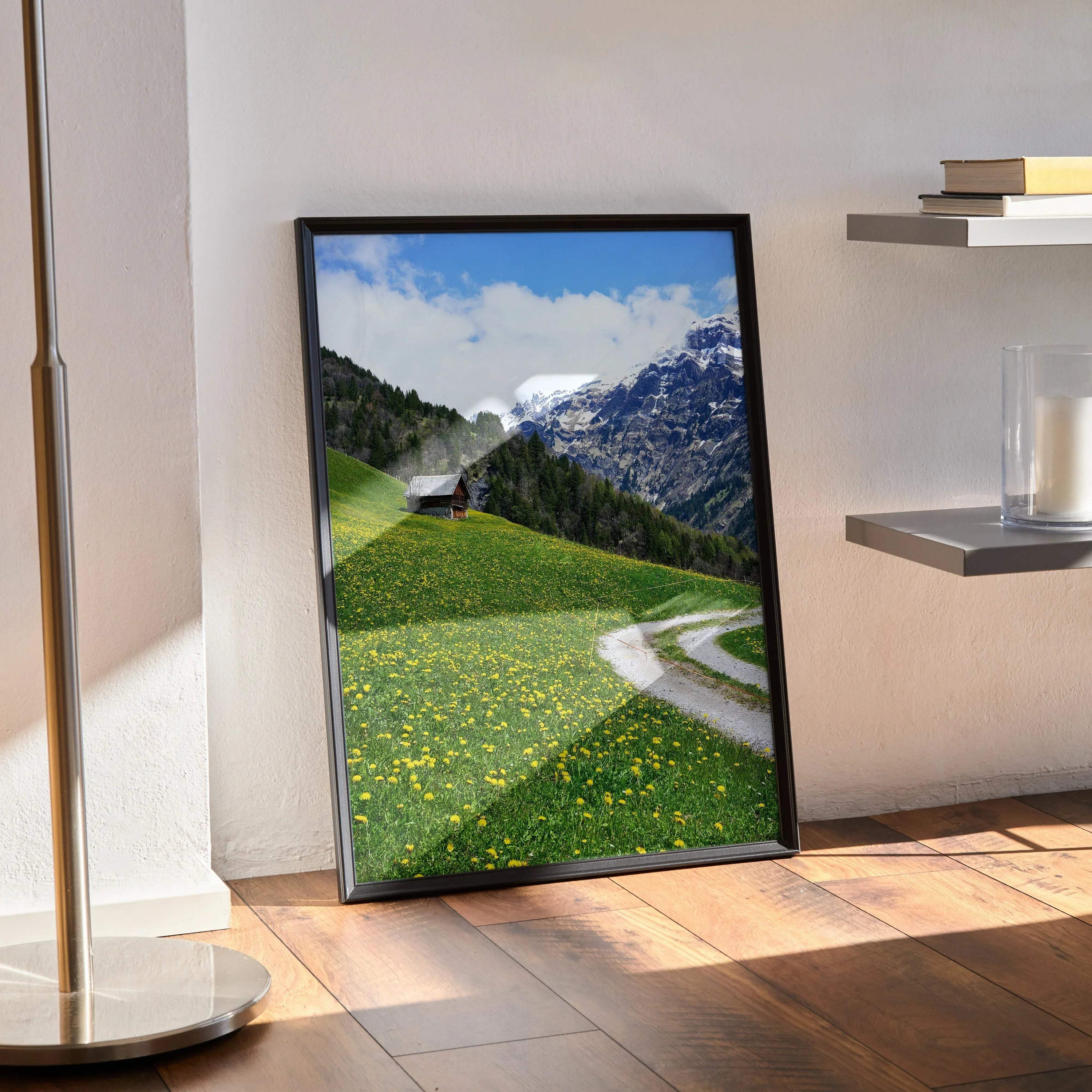 Vertical mountain landscape poster with green hills, wildflowers, and a winding path, wall art in a black frame.