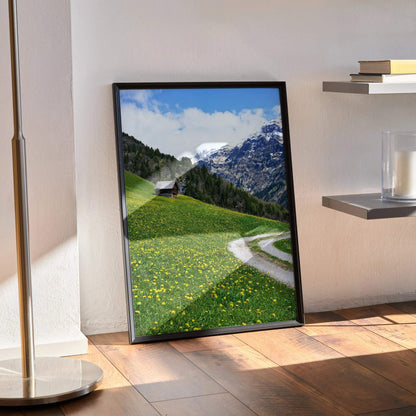 Vertical mountain landscape poster with green hills, wildflowers, and a winding path, wall art in a black frame.
