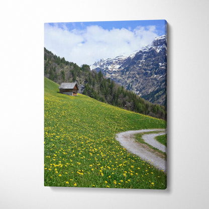 Canvas wall art featuring a mountain landscape with wildflowers, a rustic cabin, and a winding path under a blue sky.