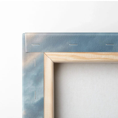 Close-up of wooden frame and blue sky canvas texture on vertical wall art panel.