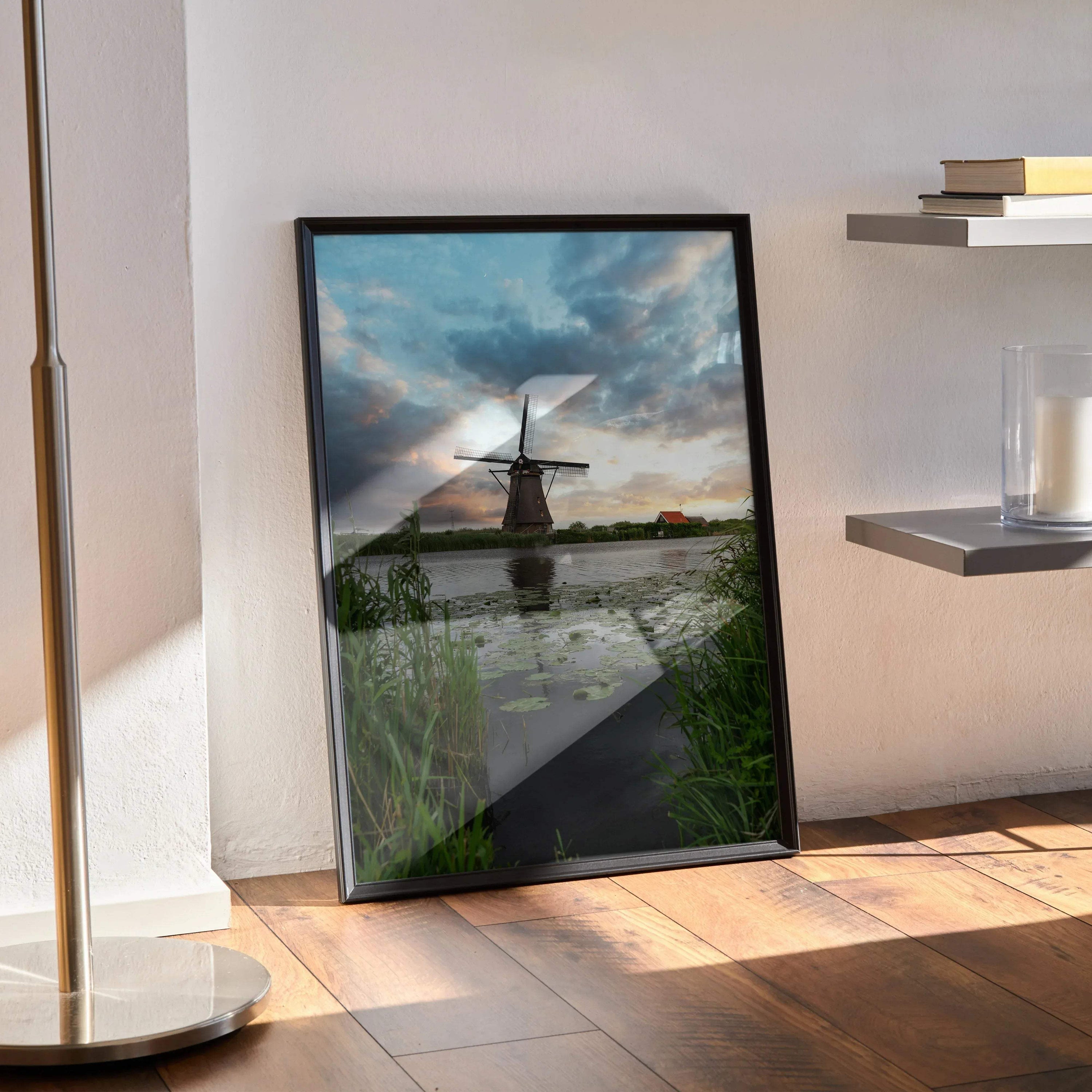 Vertical wall art poster of a windmill reflecting on water under a vibrant sunset sky.