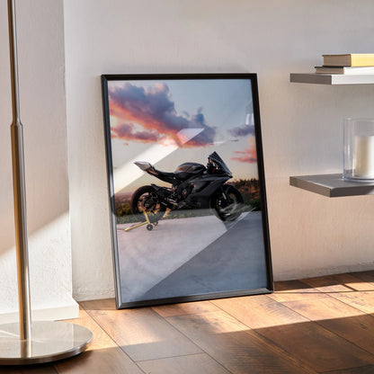 Framed Yamaha R6 motorcycle poster with sunset sky, displayed as stylish wall art on wooden floor.