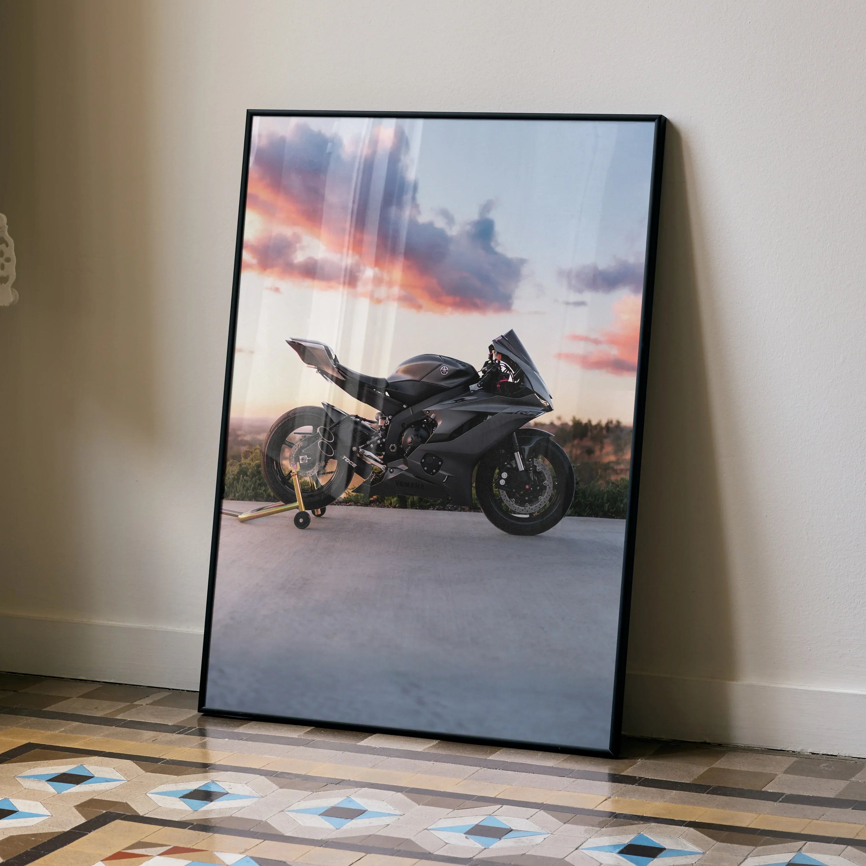 Yamaha R6 motorcycle poster with black frame against beige wall and patterned floor wall art.