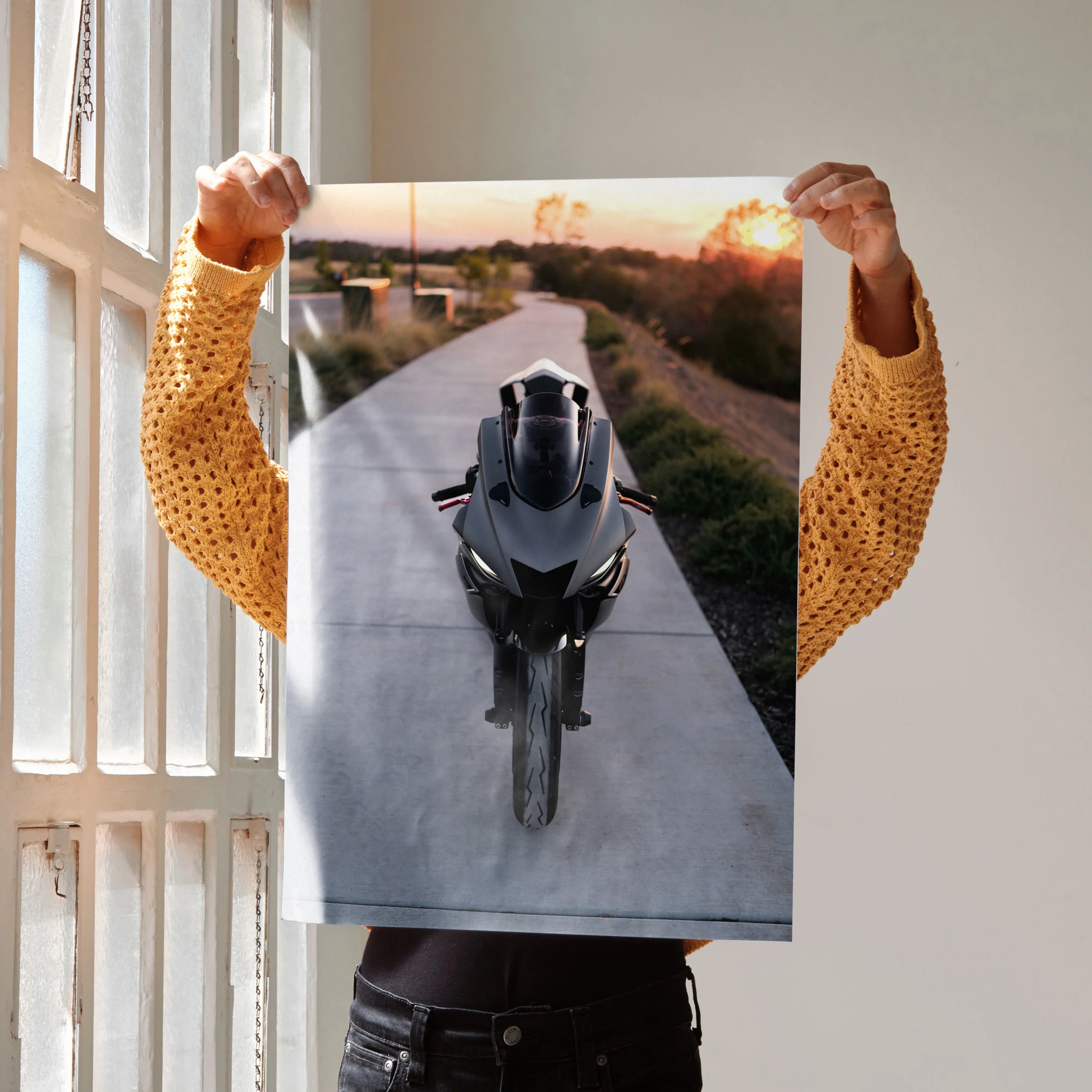 Yamaha R6 motorcycle front view poster held up indoors as wall art with sunset background.