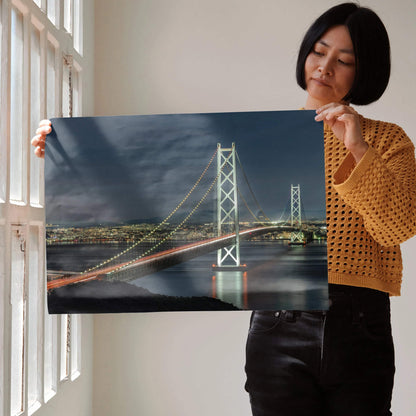 Wall art poster of a vibrant city night skyline featuring an illuminated suspension bridge over calm water.