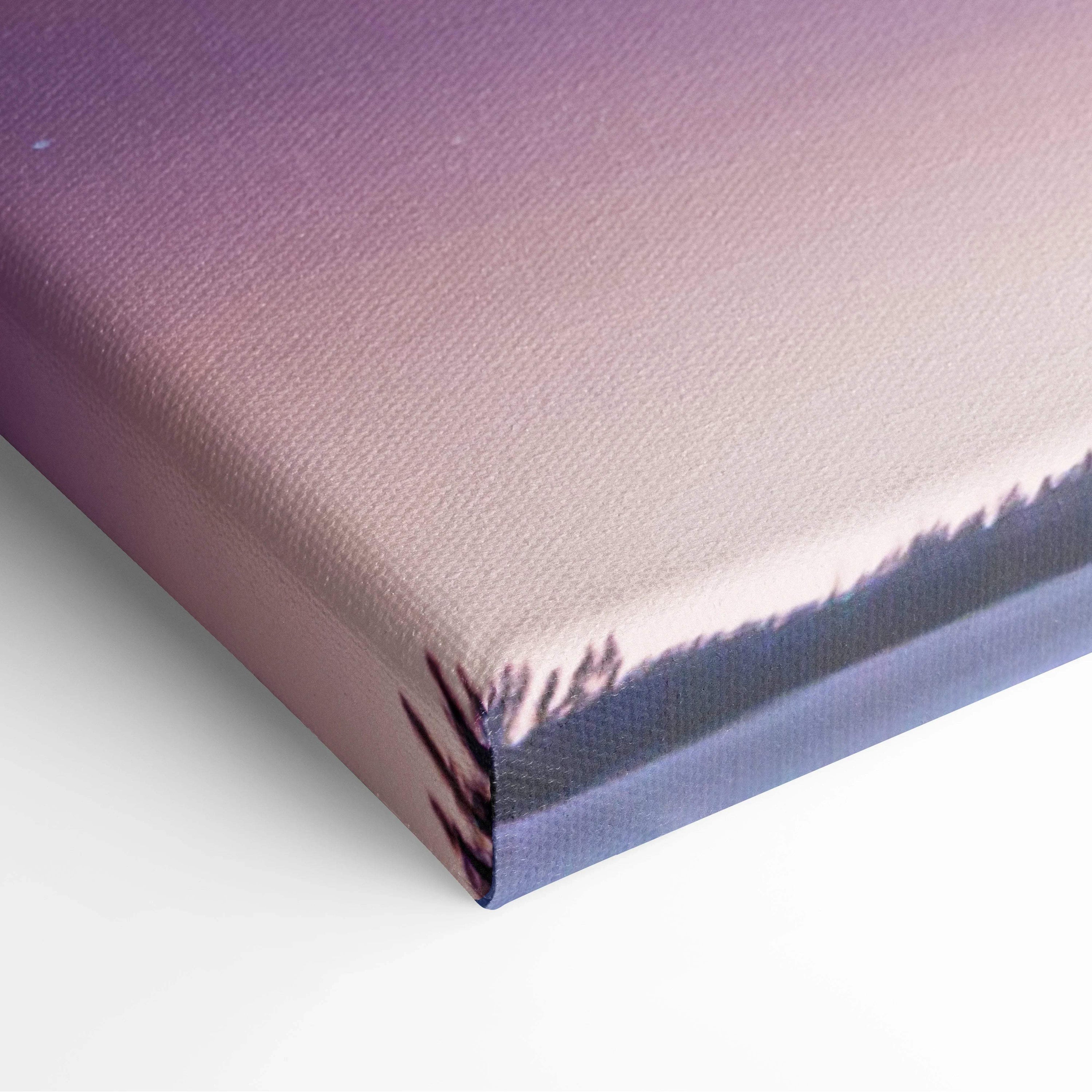 Northern lights canvas print with emerald green aurora, deep blue sky, pink-purple gradient, forest silhouettes