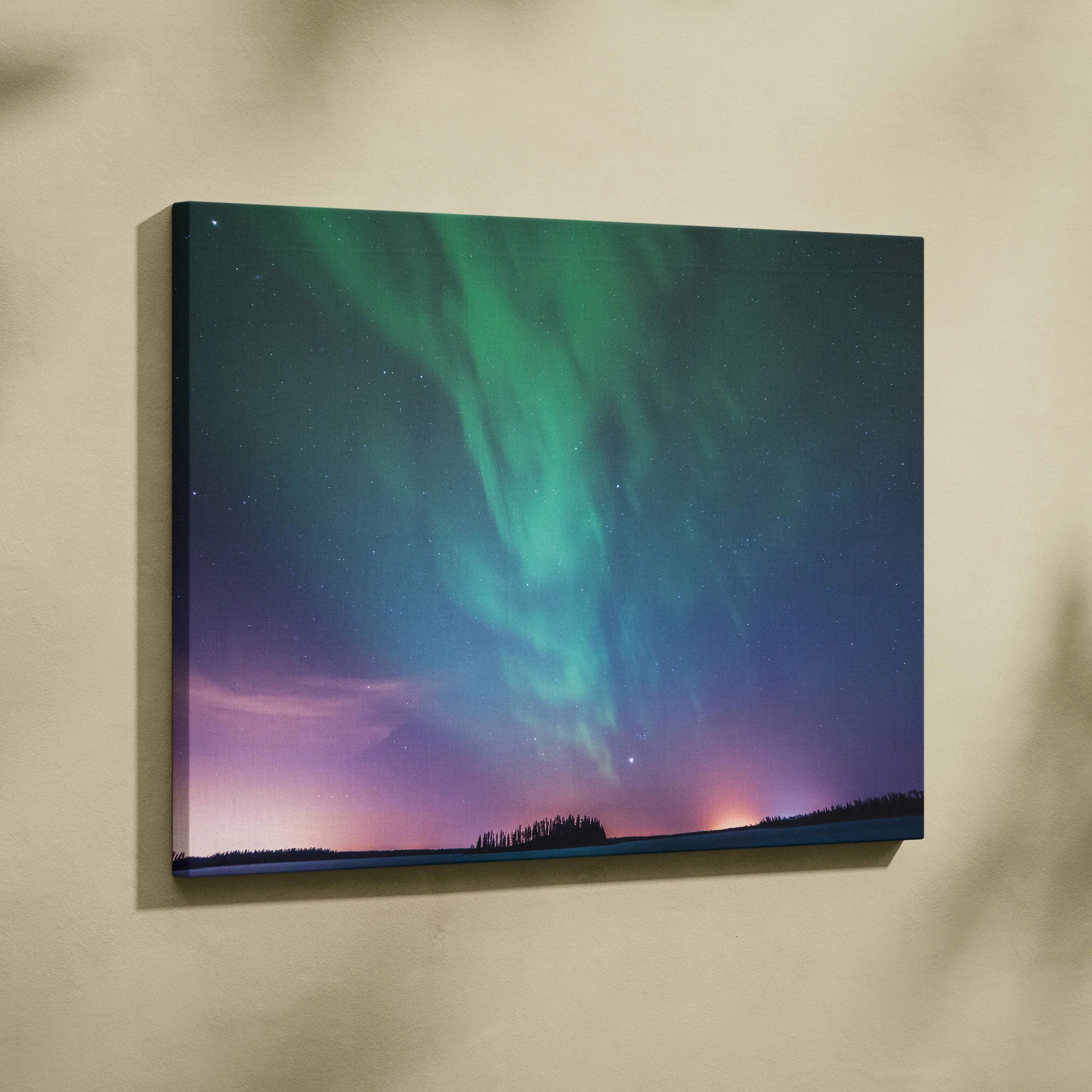 Vibrant emerald green aurora borealis over calm lake and forest silhouette canvas art