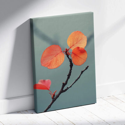 Canvas wall art featuring vibrant orange autumn leaves on a slender branch against a muted green background.