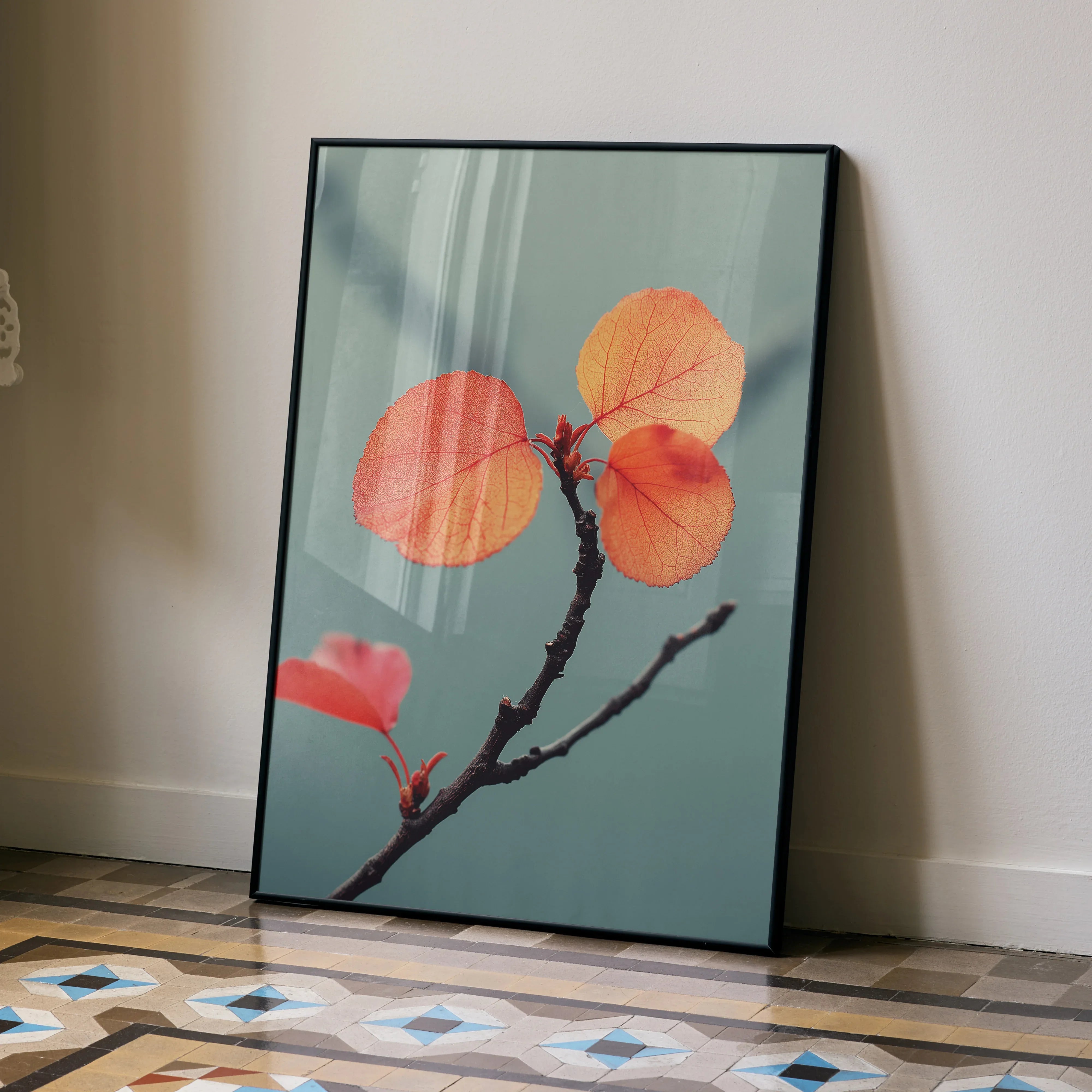 Vertical poster wall art featuring vibrant autumn leaves on a branch against a muted teal background.