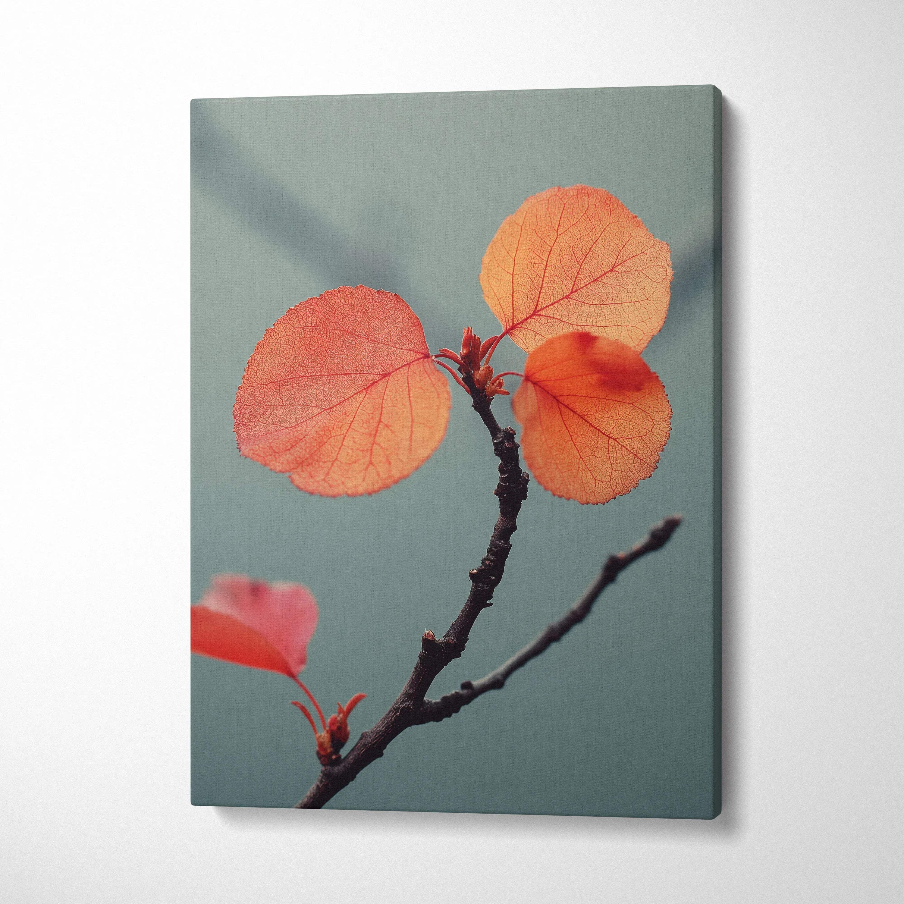Canvas wall art featuring vibrant orange autumn leaves on a slender dark branch against a muted teal background.
