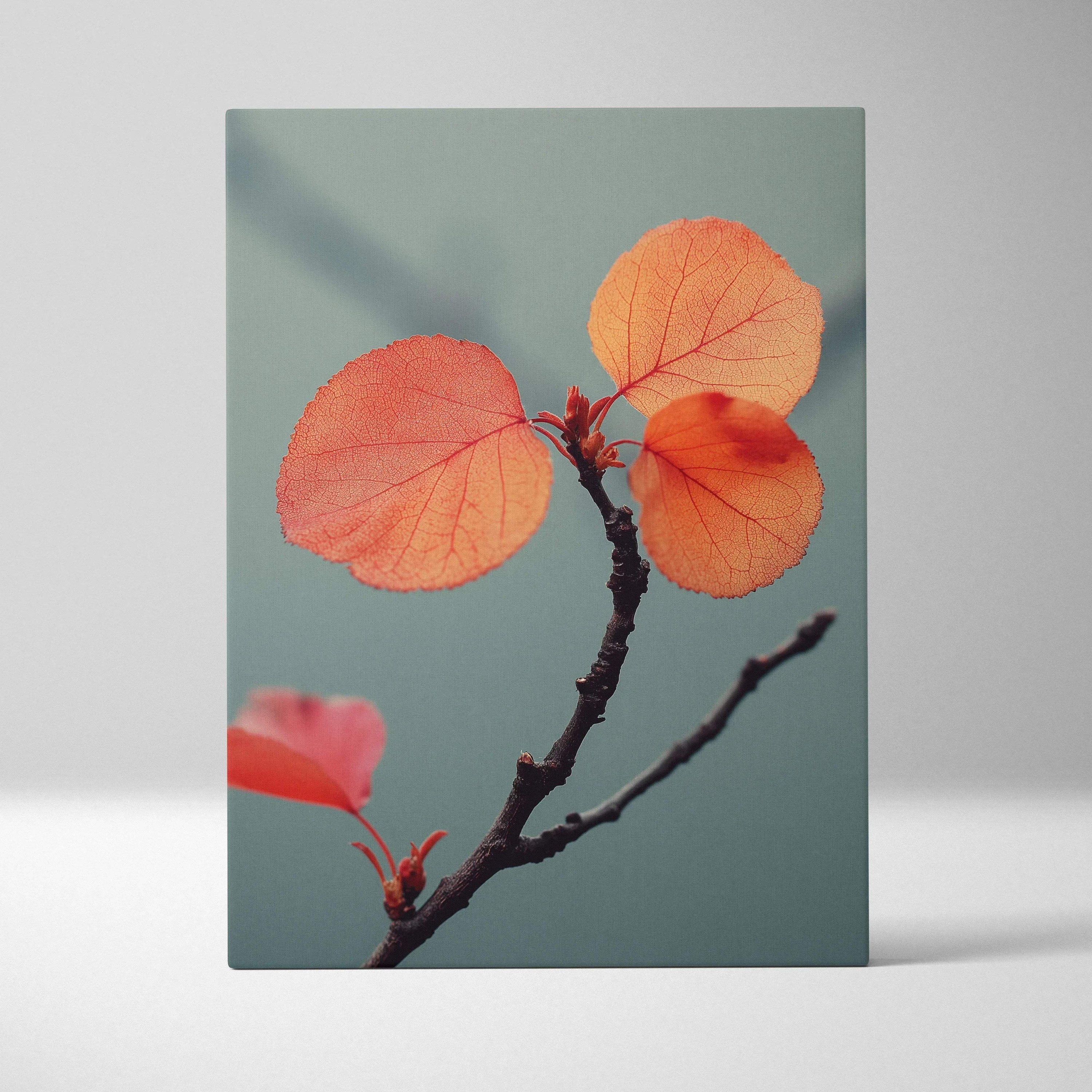 Autumn leaves in warm orange hues on a slender branch against muted blue background canvas wall art.