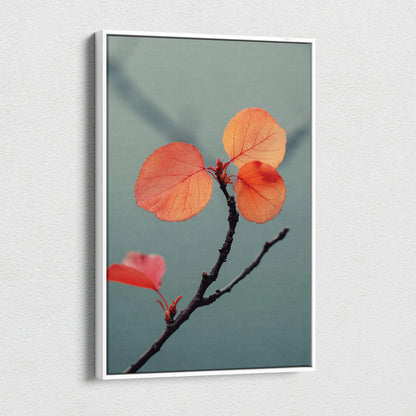 Canvas wall art featuring a close-up of orange autumn leaves on a dark branch against a muted blue background.