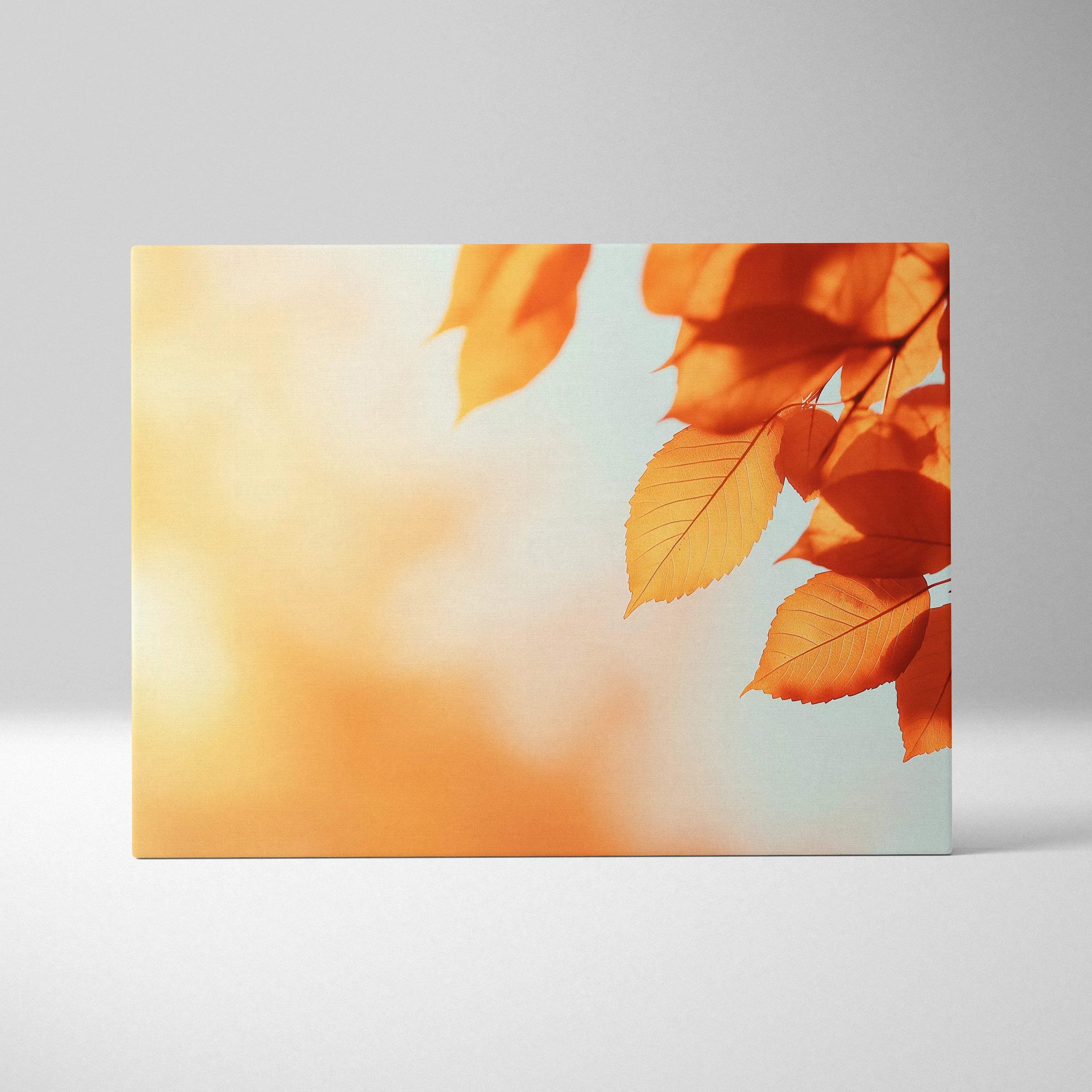 Canvas wall art featuring vibrant orange autumn leaves against a soft blue sky background.