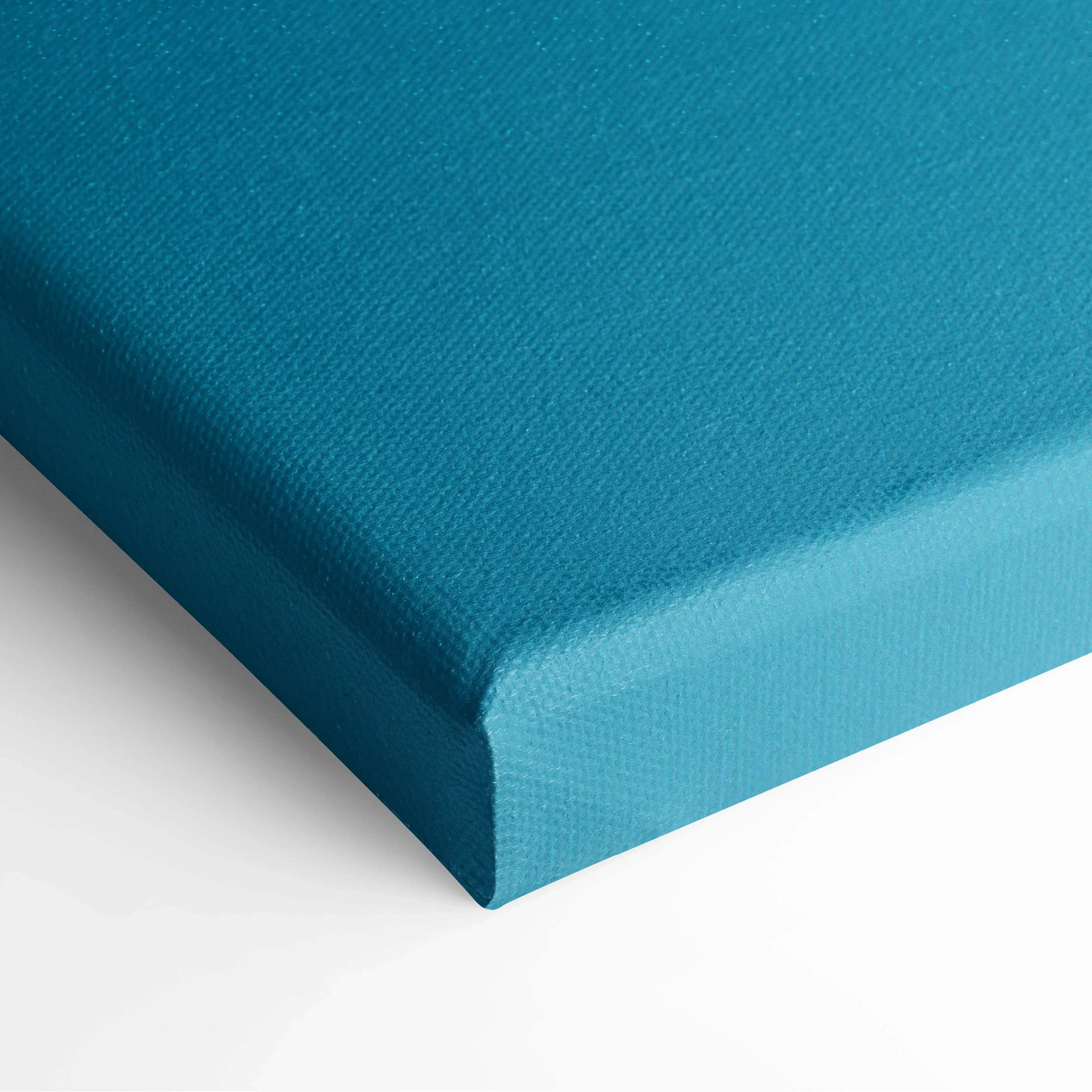 Close-up of teal blue canvas corner with textured surface, showcasing wall art material and detail.