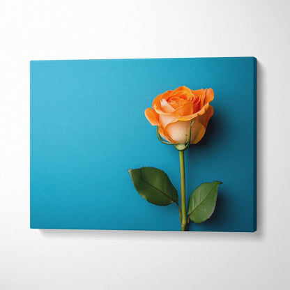 Orange rose floral canvas wall art with blue background and green leaves.