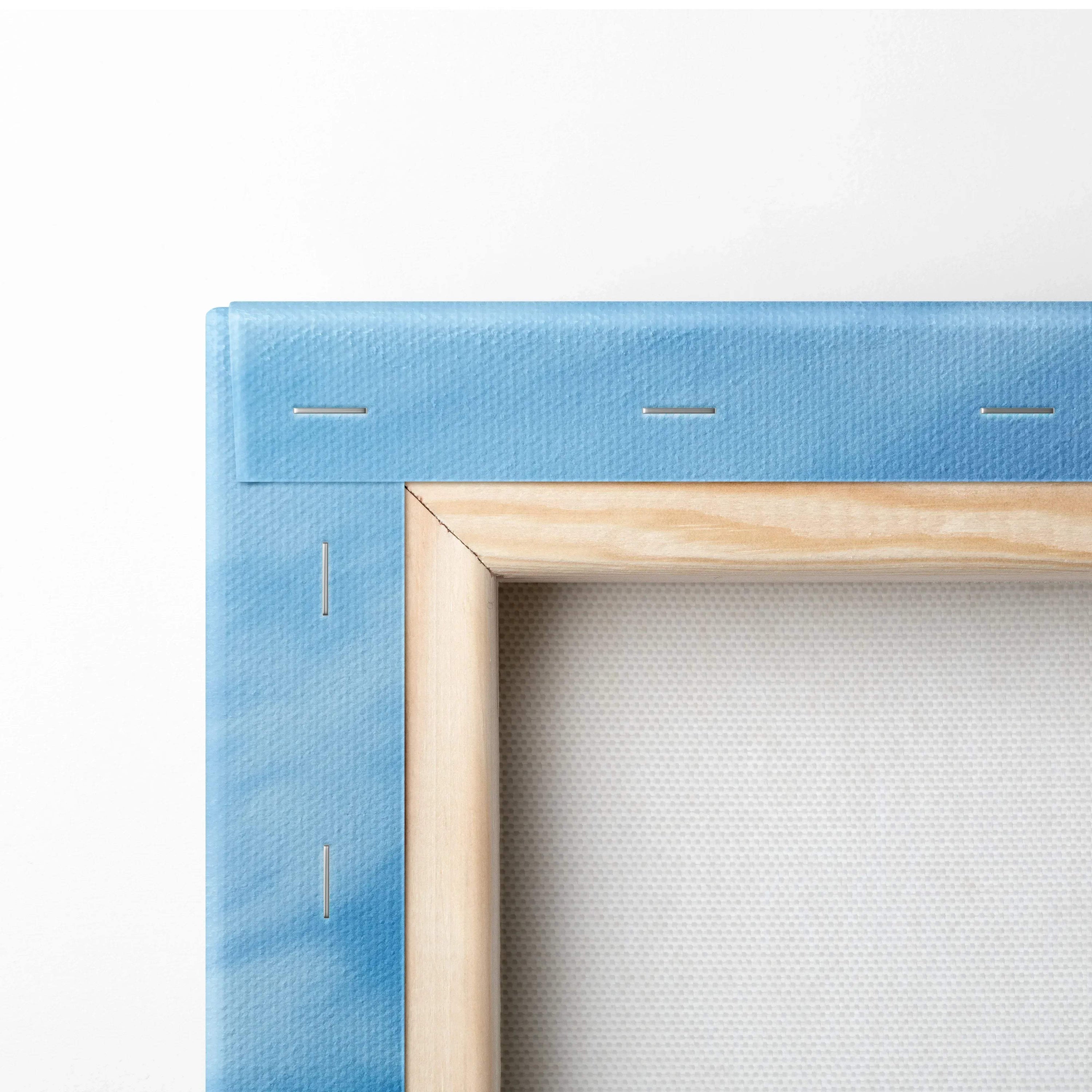Close-up of blue canvas stretched over wooden frame showing corner stapling for wall art assembly.