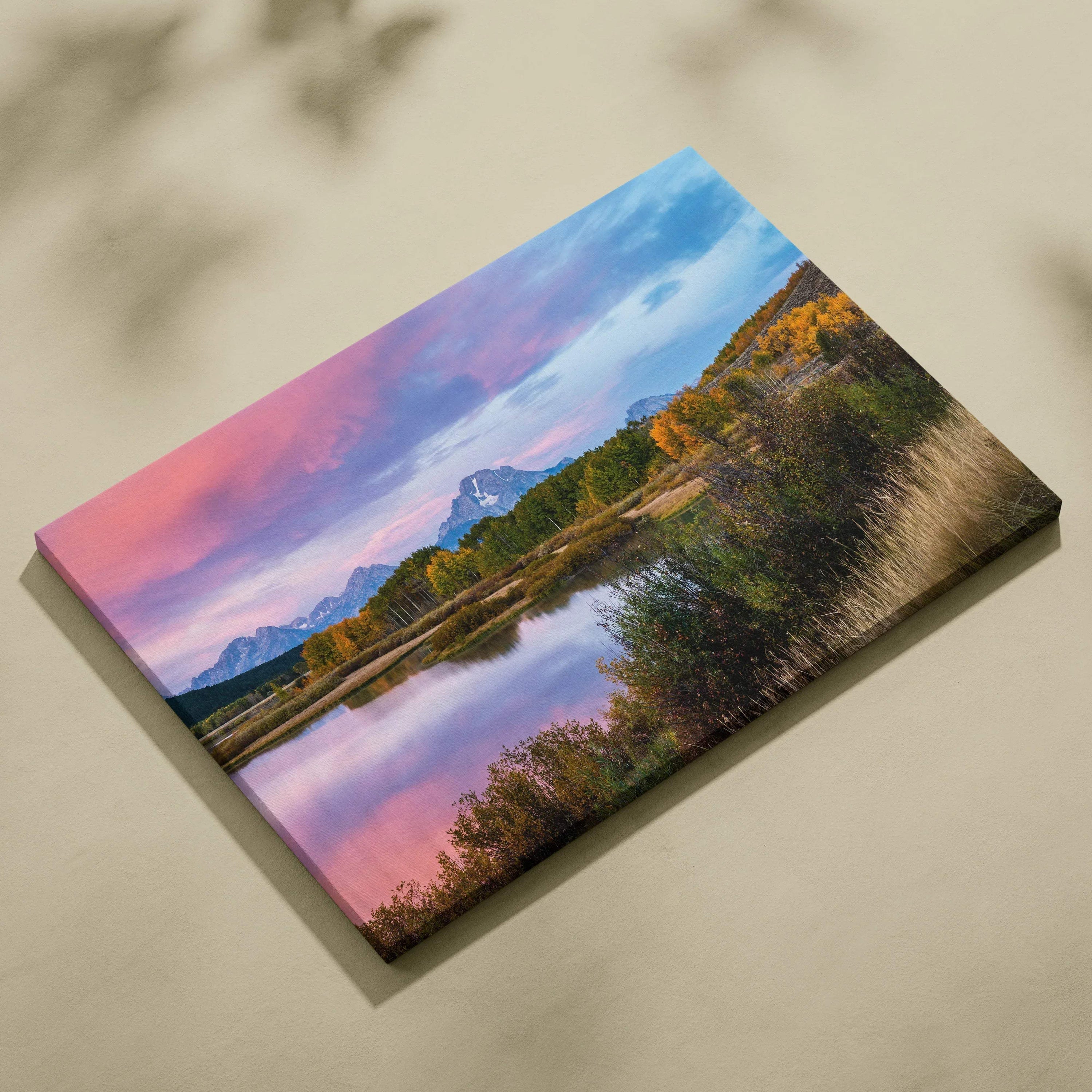 Canvas wall art featuring a vibrant mountain sunset with pink and blue skies reflecting on a calm lake.