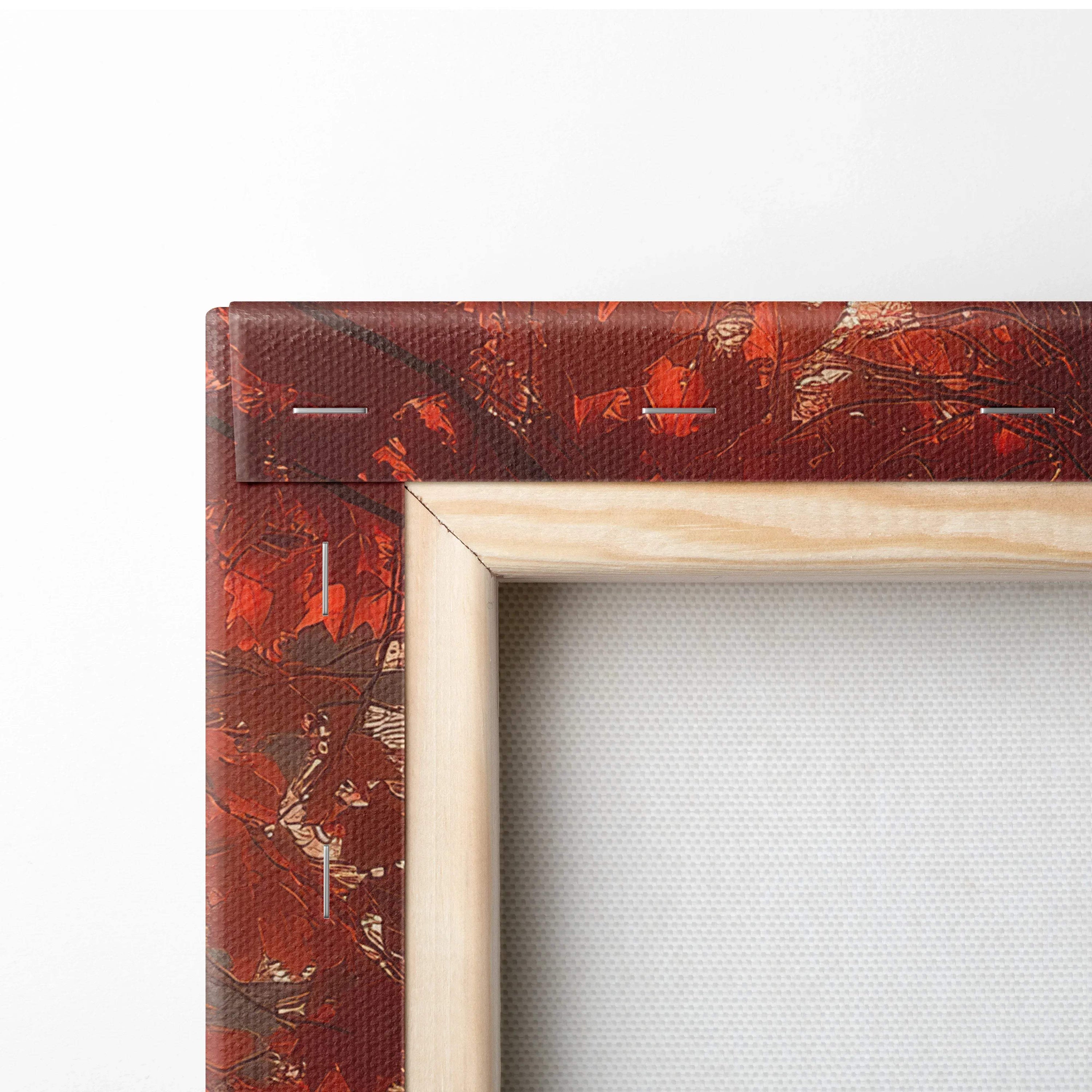Close-up detail of wooden framed canvas wall art with deep red autumn landscape design.