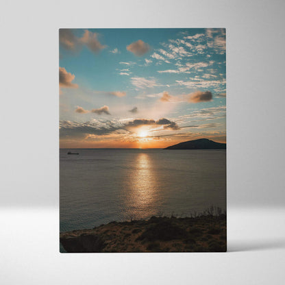 Canvas wall art featuring a vibrant ocean sunset with clouds and a glowing horizon over calm water.