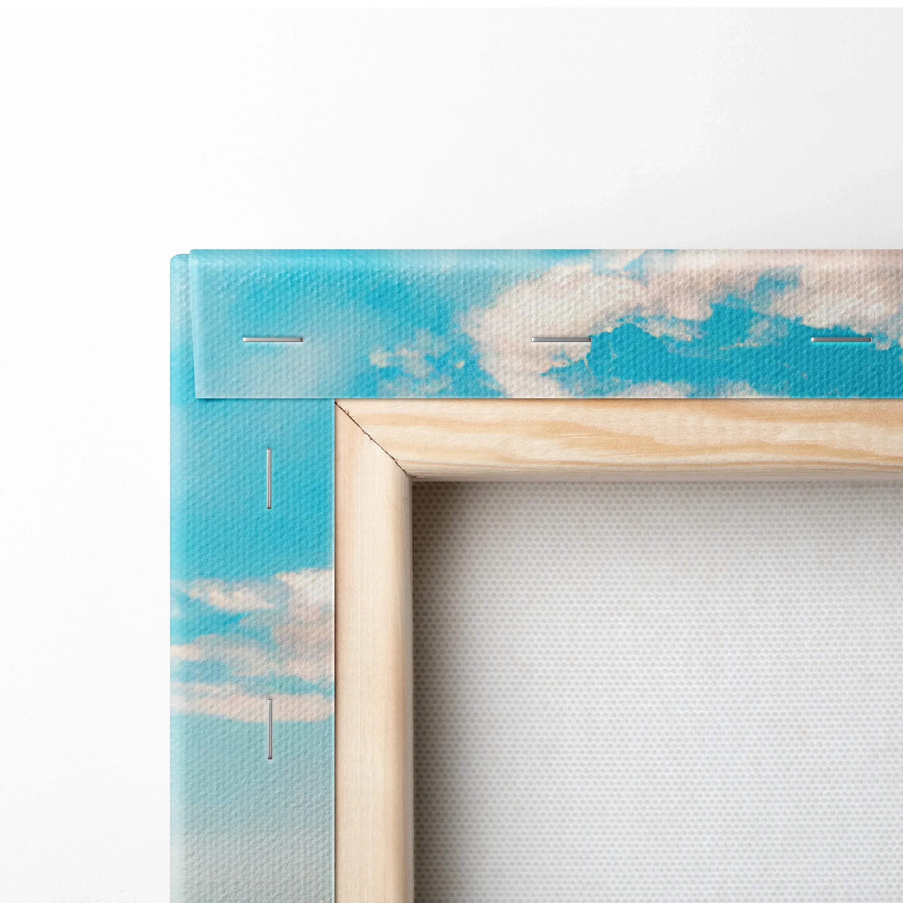 Close-up of wooden frame and blue sky corner on canvas wall art print.