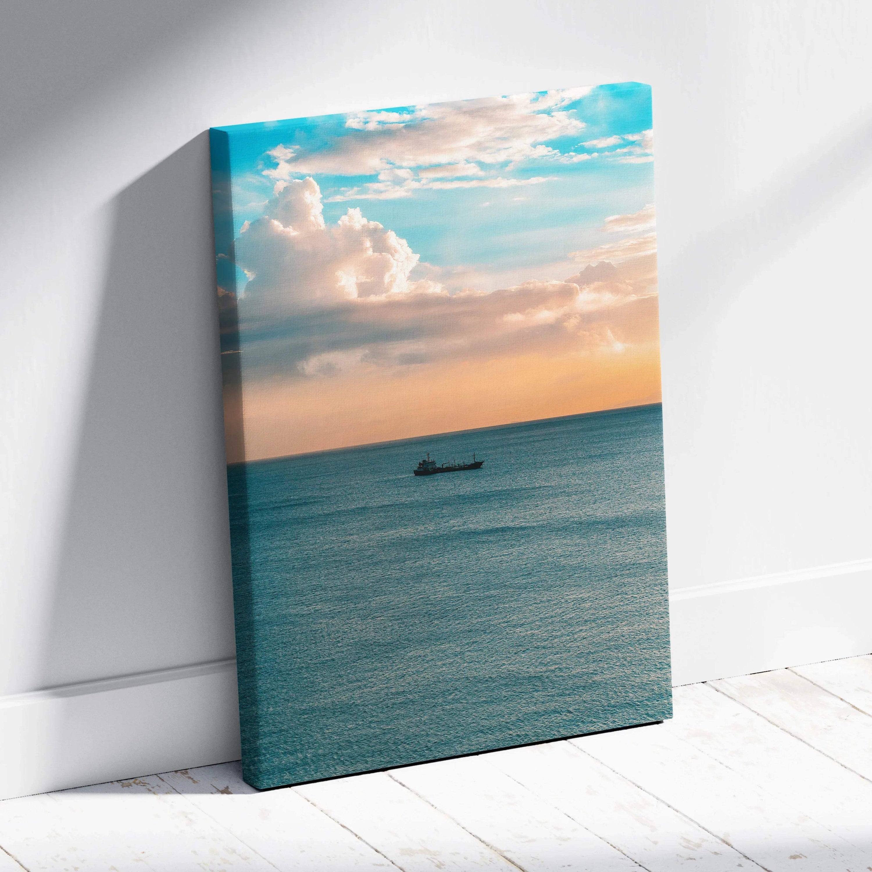 Canvas wall art of a tranquil ocean at sunset with soft clouds and a small boat on calm water.