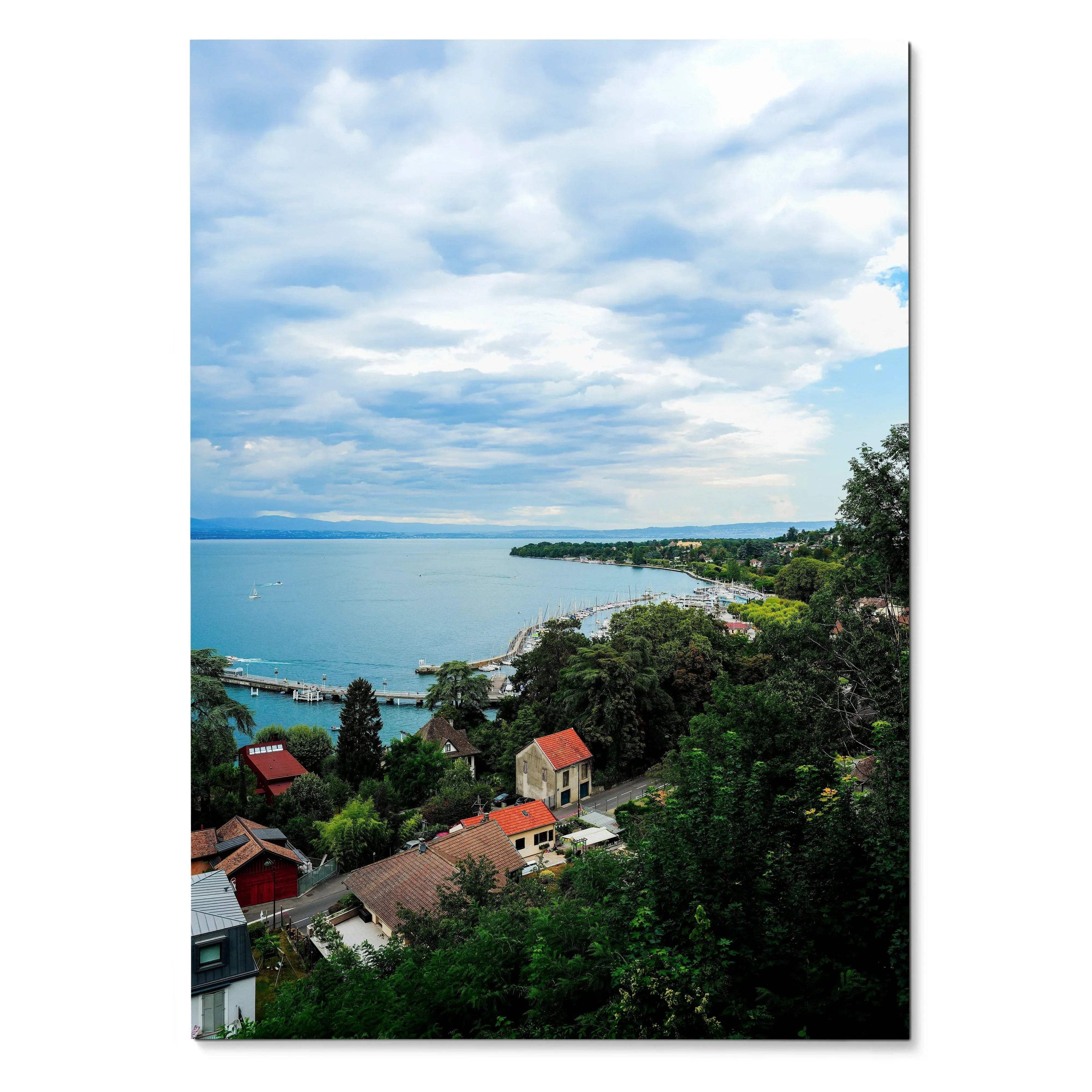 Vertical tranquil nature landscape poster showing a calm lake, cloudy sky, houses, and lush greenery wall art.