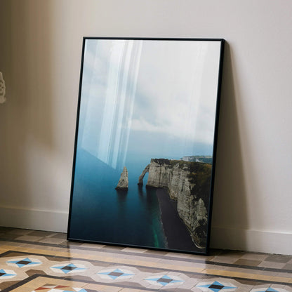 Ocean cliff and rock formations vertical poster wall art with soft blue sky and water.