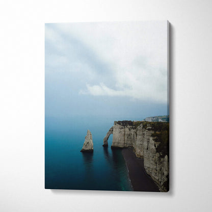 Canvas wall art featuring dramatic cliffs and calm ocean waters under a cloudy sky.
