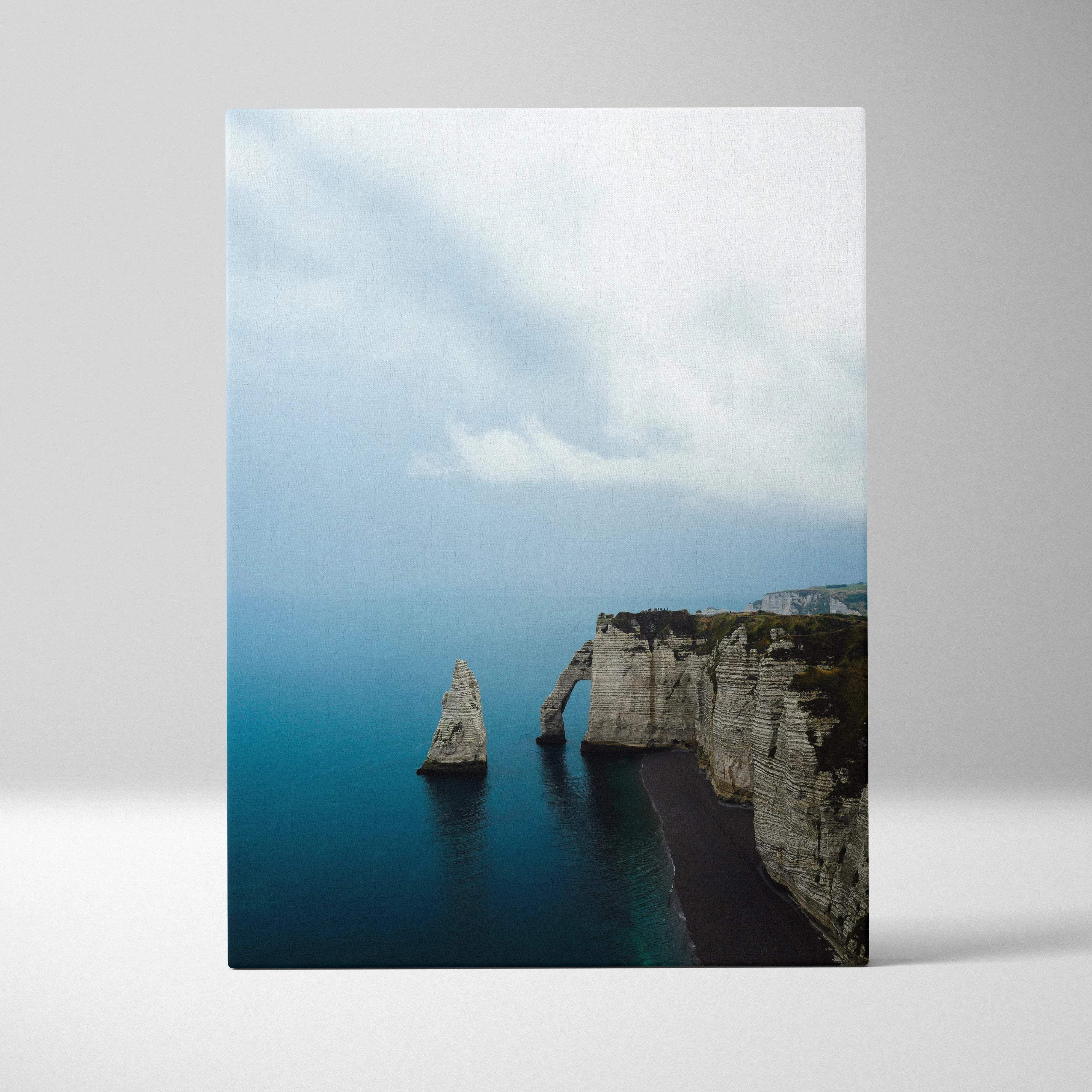 Rectangular canvas wall art of a dramatic coastal cliff landscape with sea arch and calming blue tones
