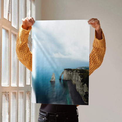 Ocean beach cliff vertical poster with sailboat and calm blue water wall art.