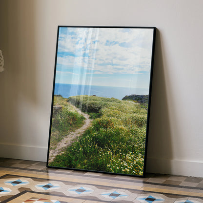 Vertical wall art poster featuring a vibrant floral nature scene with a grassy path under a blue sky.