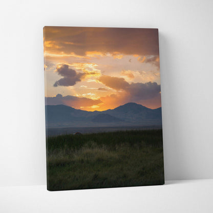 Mountain sunset with glowing orange sky over dark hills canvas wall art.